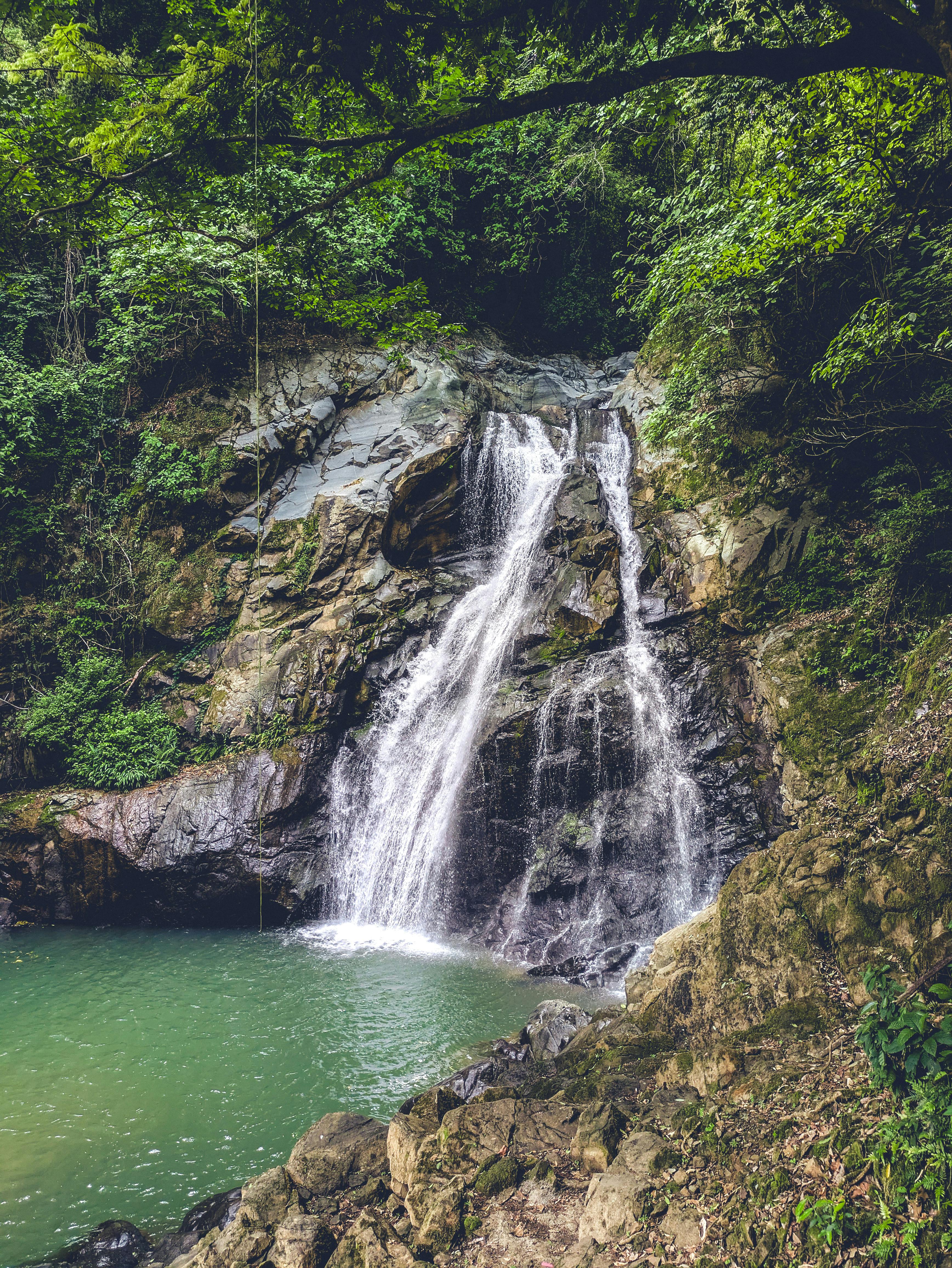 Hidden waterfall surrounded by rainforest in Costa Rica